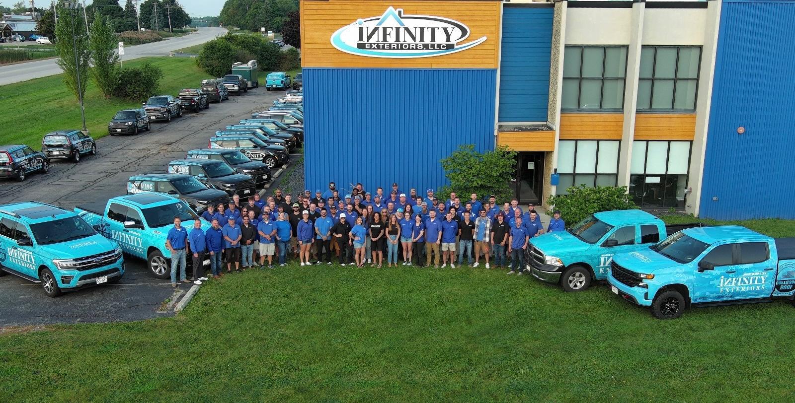 Infinity Exteriors team and their branded blue trucks and SUVs outside their building.