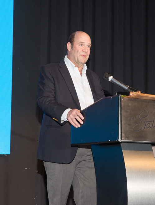 Public address system, Suit trousers, Dress shirt, Podium, Microphone, Lectern, Sleeve, Collar