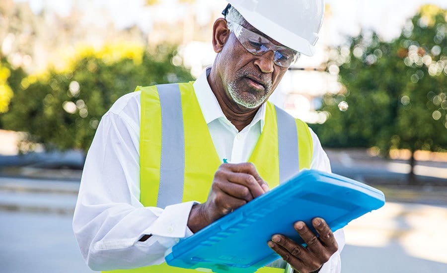 Hard hat, High-visibility clothing, Glasses, Beard, Workwear, Helmet, Glove, Gesture, Headgear