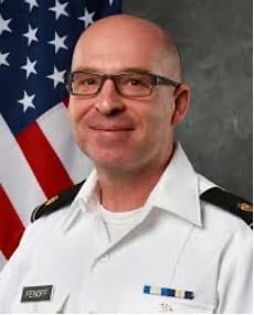 Smiling bald American military officer Fendoff with glasses.