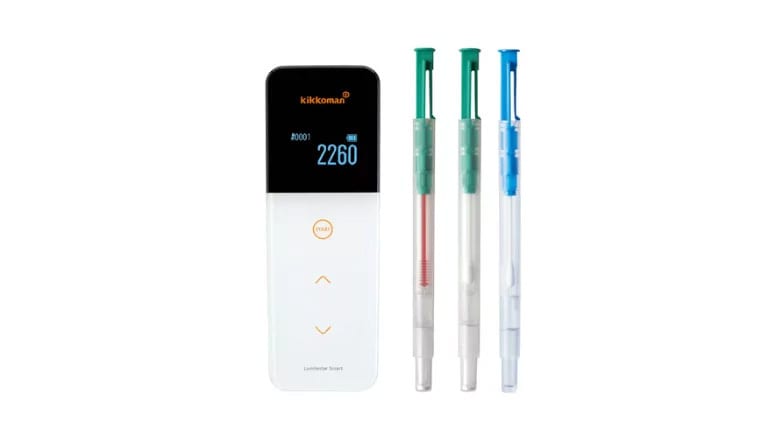 Kikkoman smart ATP hygiene monitor and three test swabs.