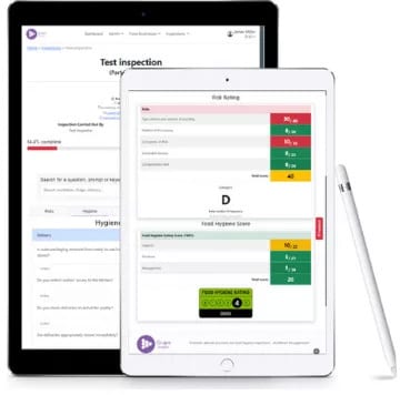 Tablets displaying digital inspection forms and hygiene scores, with a stylus.
