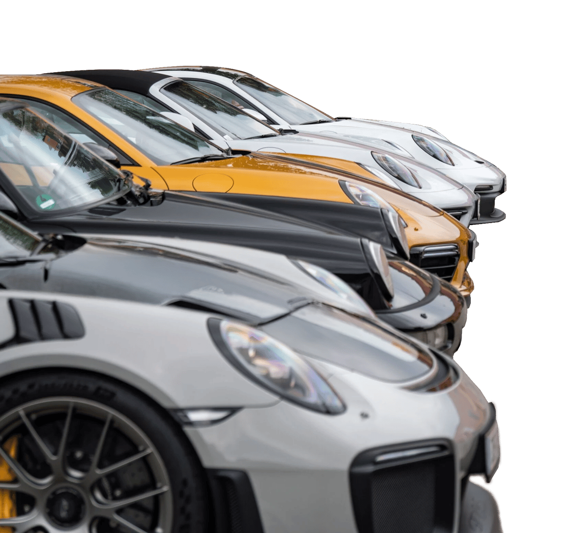 A line of sports cars, including gold, black, silver, and white Porsches, parked together.