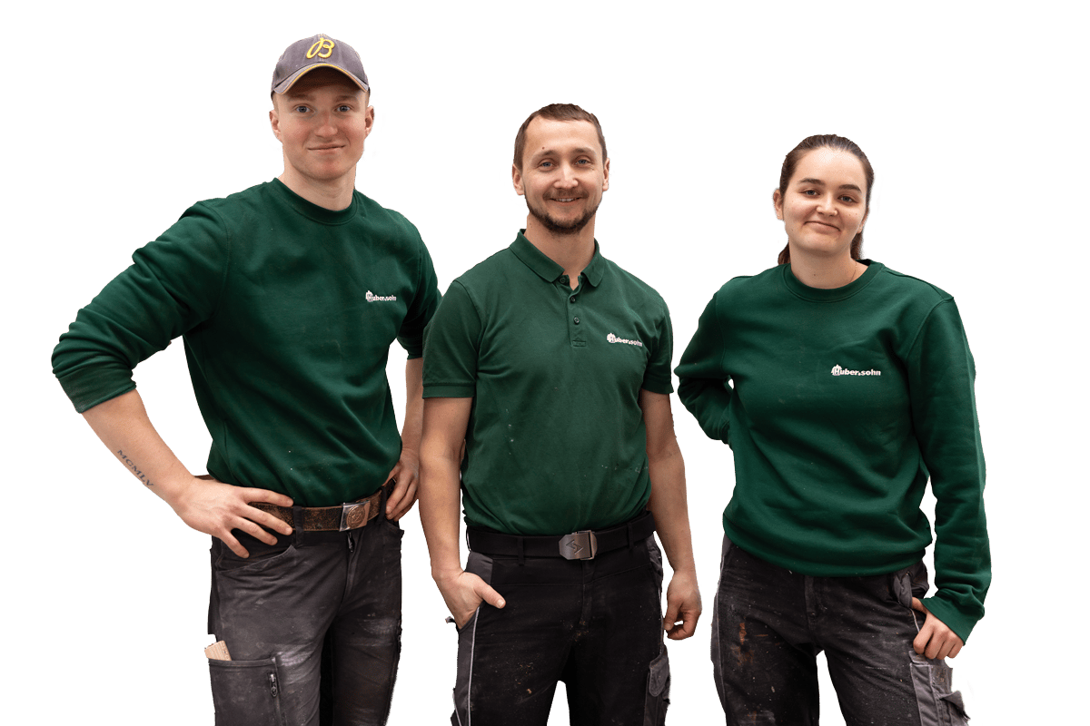 Three smiling workers in green uniform, two men and one woman, standing against a green background.