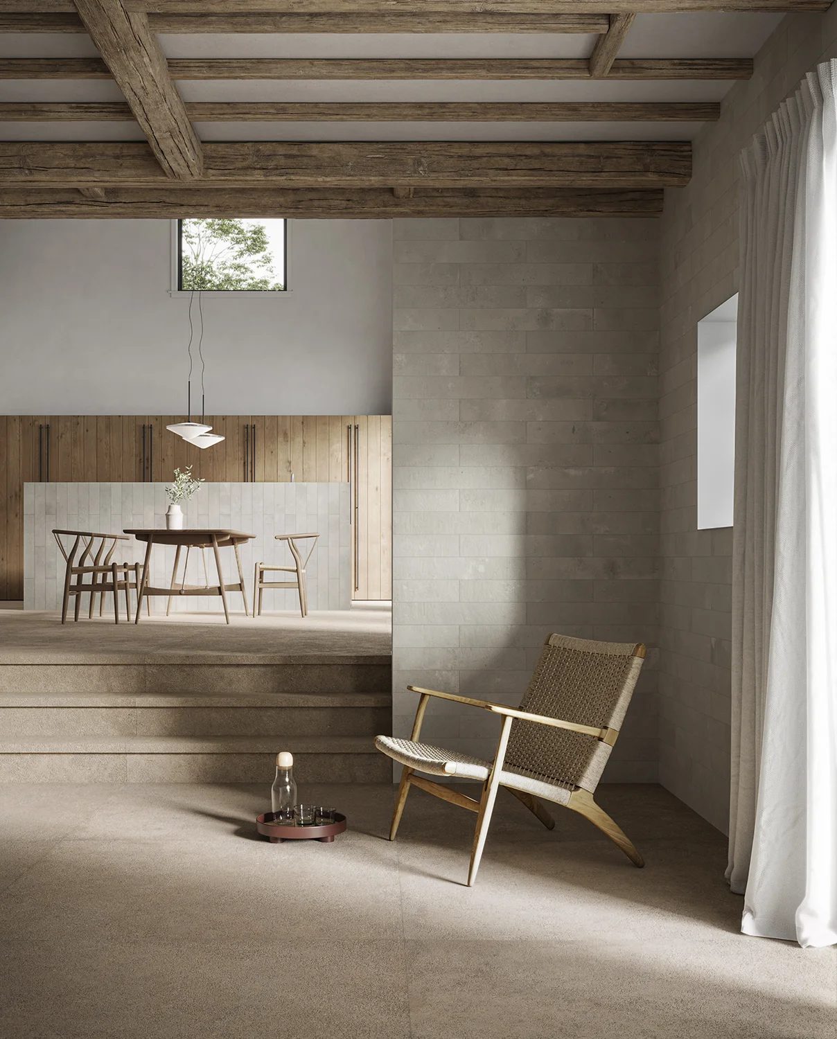 A multi-level room with exposed wooden beams, a dining area, a sitting area, and neutral tones.