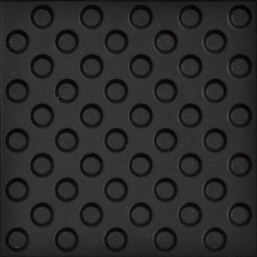Black tactile paving with a grid of raised circular dots.