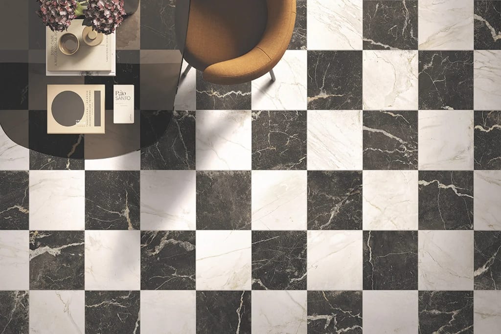 Black and white marble checkerboard floor with a coffee table and chair, overhead view.