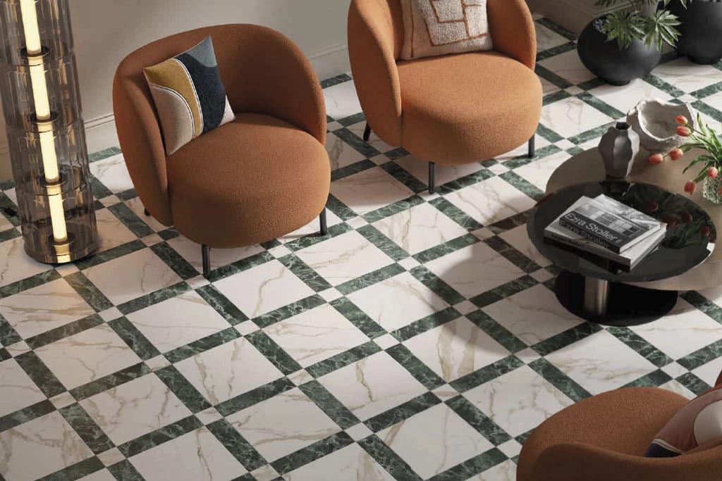Green and white marble diamond floor with orange chairs, coffee table, and modern lamp.