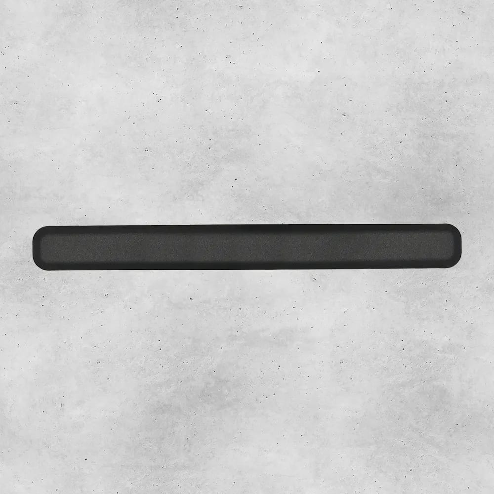 Dark gray rounded bar on a textured light gray background.