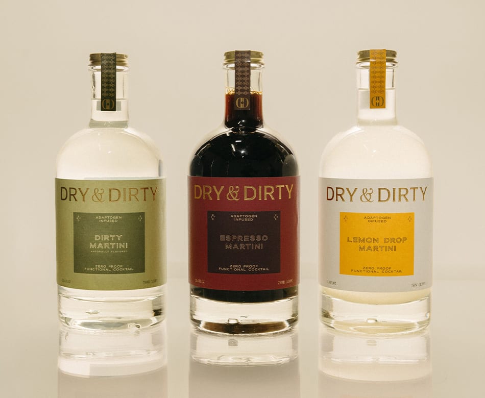 Three Dry & Dirty non-alcoholic martini bottles: Dirty, Espresso, and Lemon Drop flavors.