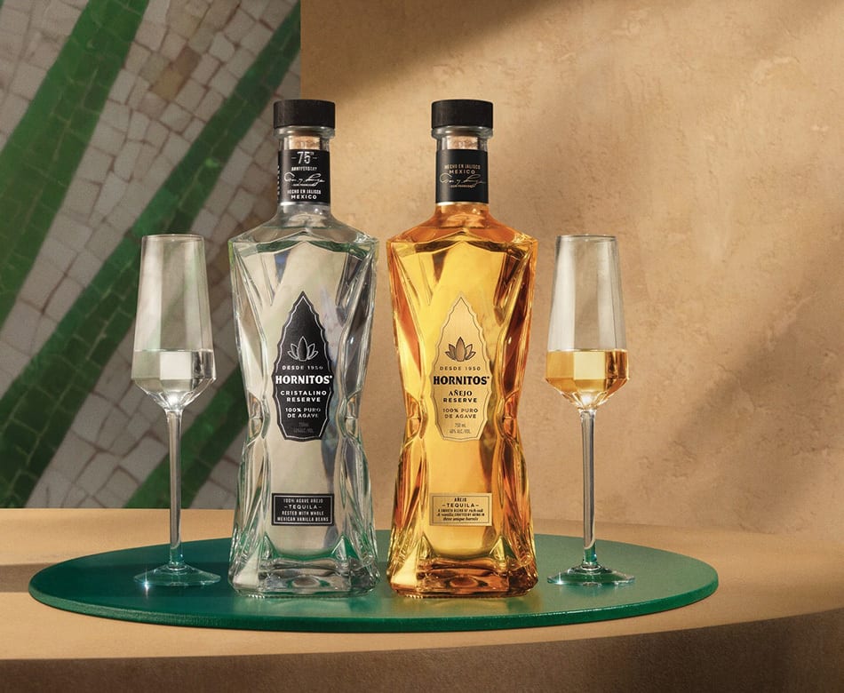 Two Hornitos tequila bottles (Cristalino, Añejo) and two glasses on a green tray.