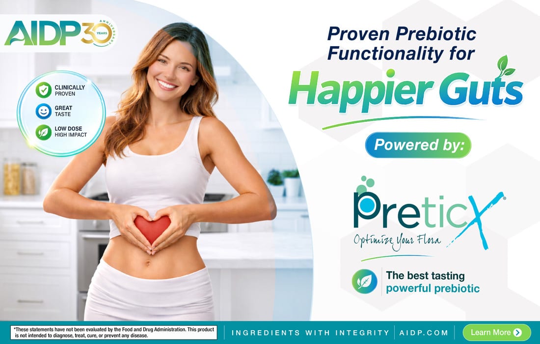 A smiling woman forming a heart shape on her stomach, promoting PreticX prebiotic for happier guts.