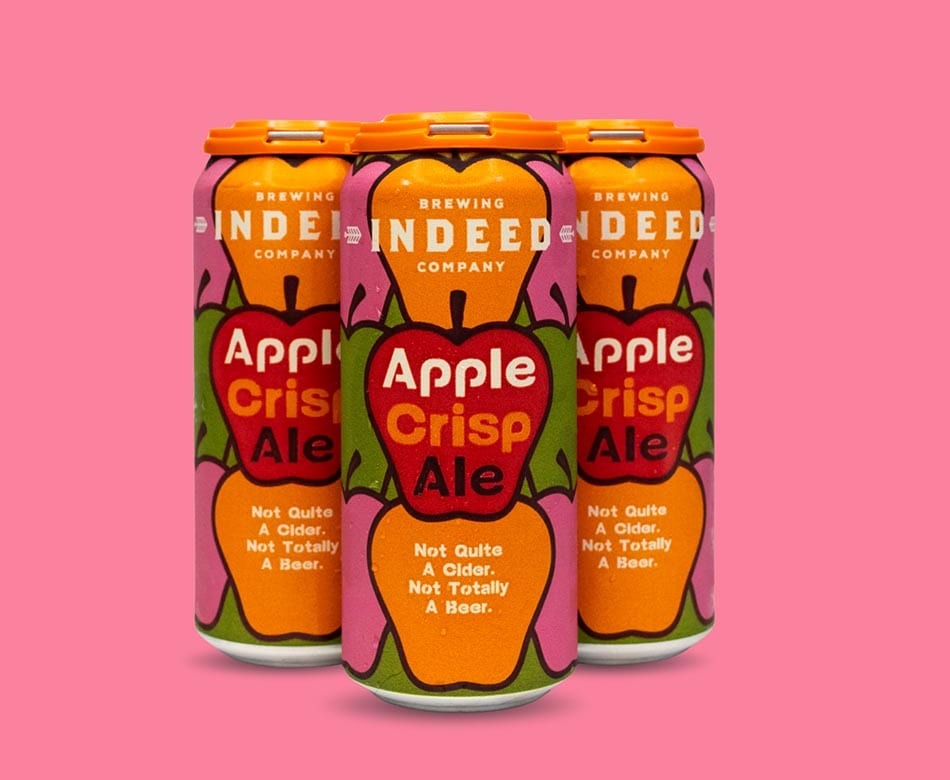 Three cans of Indeed Brewing Apple Crisp Ale, described as "Not Quite A Cider. Not Totally A Beer."