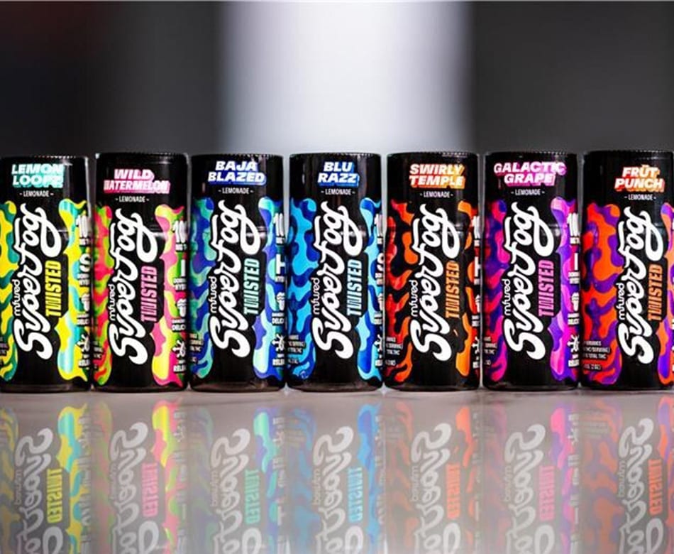 Seven colorful SuperFog Twisted Lemonade cans in a row, with reflections.