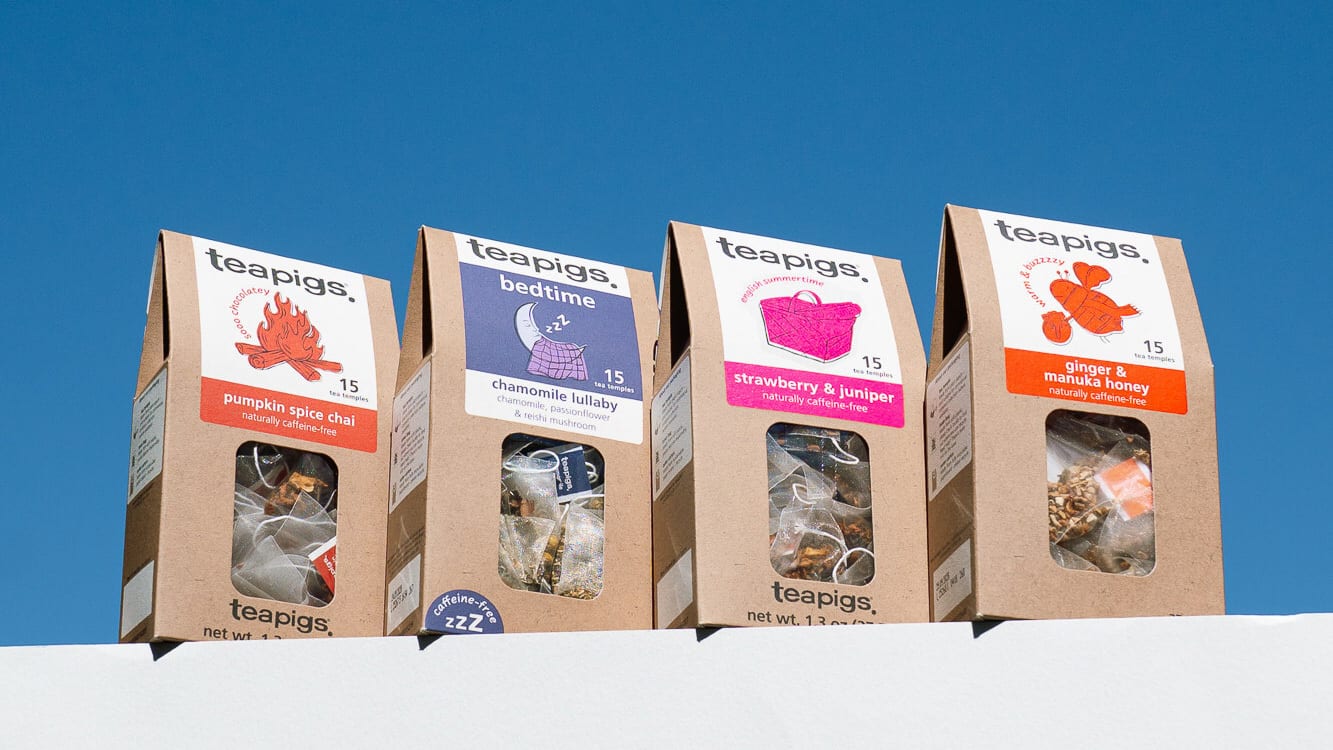 Four Teapigs tea boxes (pumpkin spice chai, bedtime, strawberry & juniper, ginger & manuka honey) against a blue sky.