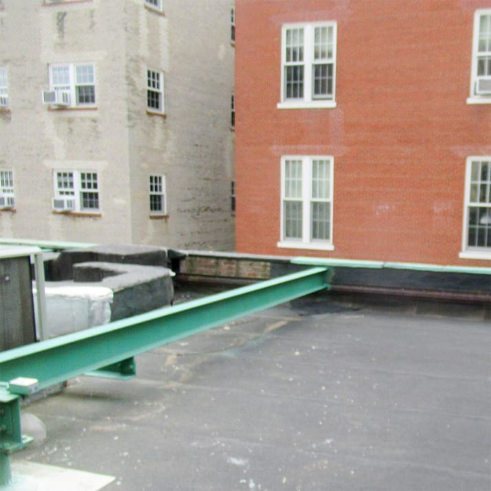 Closeup of the corner of an apartment building roof.