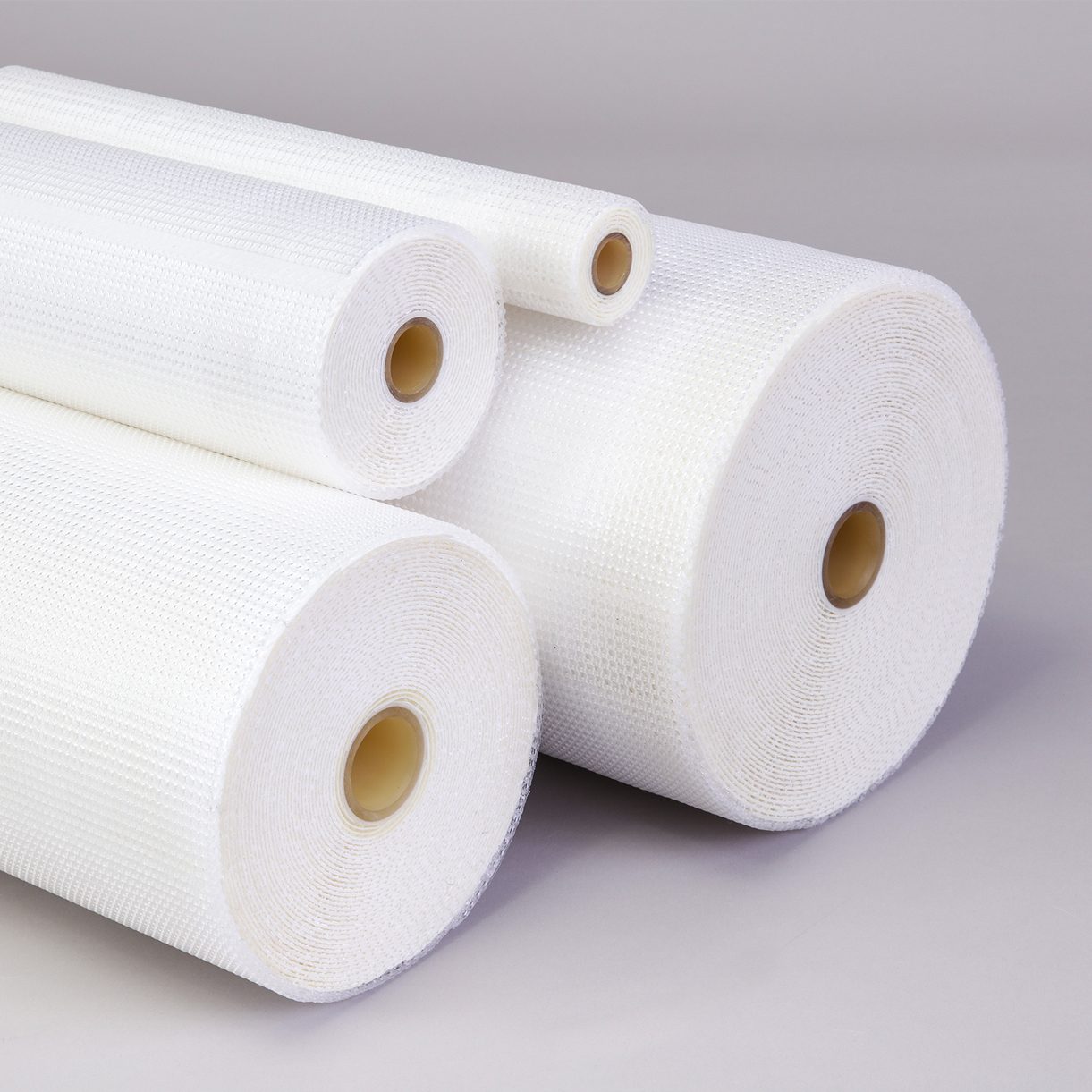 Multiple rolls of white mesh material.