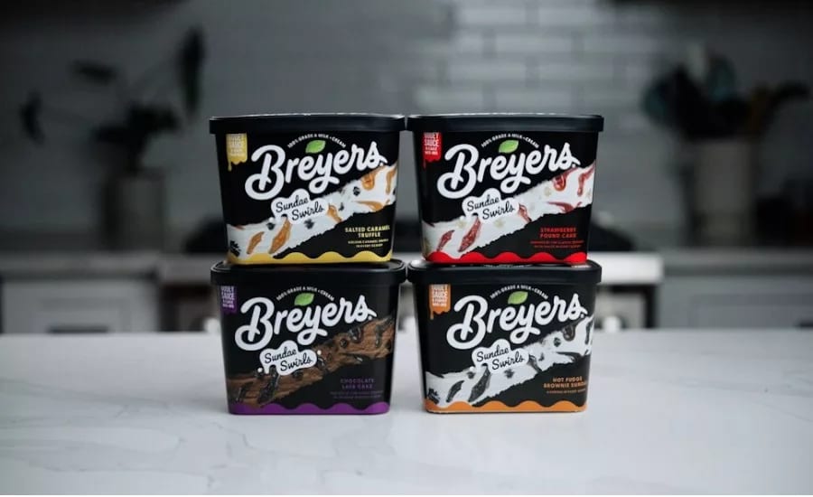 Four Breyers Sundae Swirls ice cream tubs in various flavors, arranged in a grid.