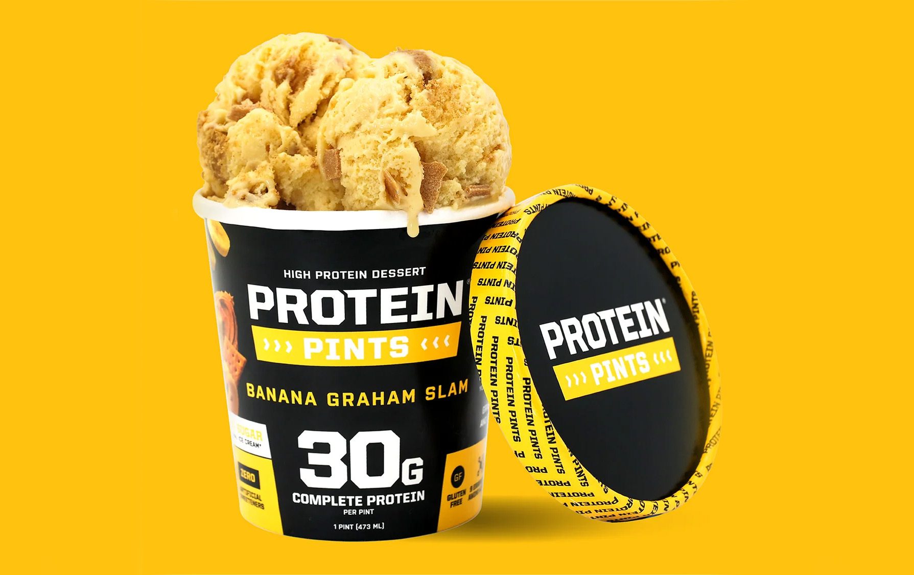 A black pint of Protein Pints high protein dessert, Banana Graham Slam flavor, with scoops of ice cream and lid.
