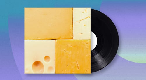 Four blocks of cheese forming a square with a black vinyl record.
