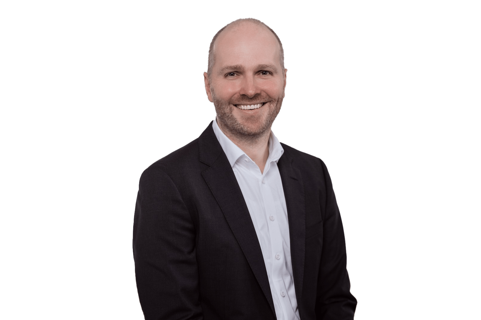Smiling bald man with a beard wearing a suit, looking at the camera against a white background.