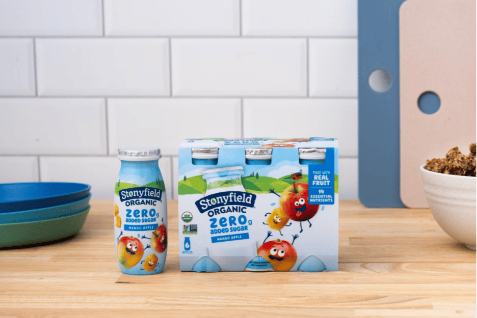 Stonyfield Organic Zero Added Sugar Mango Apple yogurt drinks (bottle and 6-pack) on a counter.
