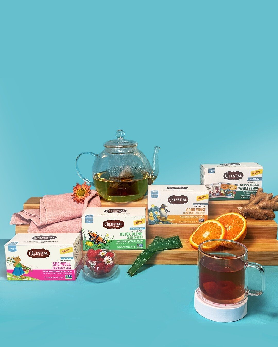Celestial Seasonings teas (Detox, Good Vibes, She-Well, Variety Pack), teapot, mug, oranges, ginger.