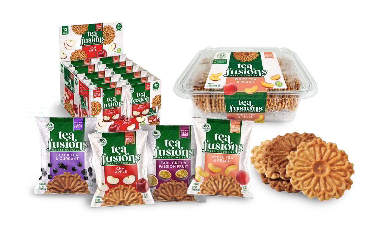 An assortment of Tea Fusions waffle cookies, including display boxes, containers, and individual pouches of various flavors like Chai Apple, Black Tea & Currant, Earl Grey & Passion Fruit, and White Tea & Peach, alongside loose cookies.