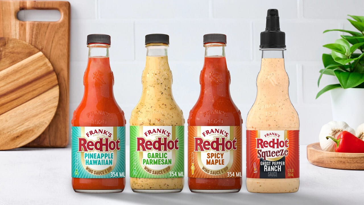 Four bottles of Frank's RedHot wing sauces and dips: Pineapple Hawaiian, Garlic Parmesan, Spicy Maple, and Ghost Pepper Ranch.