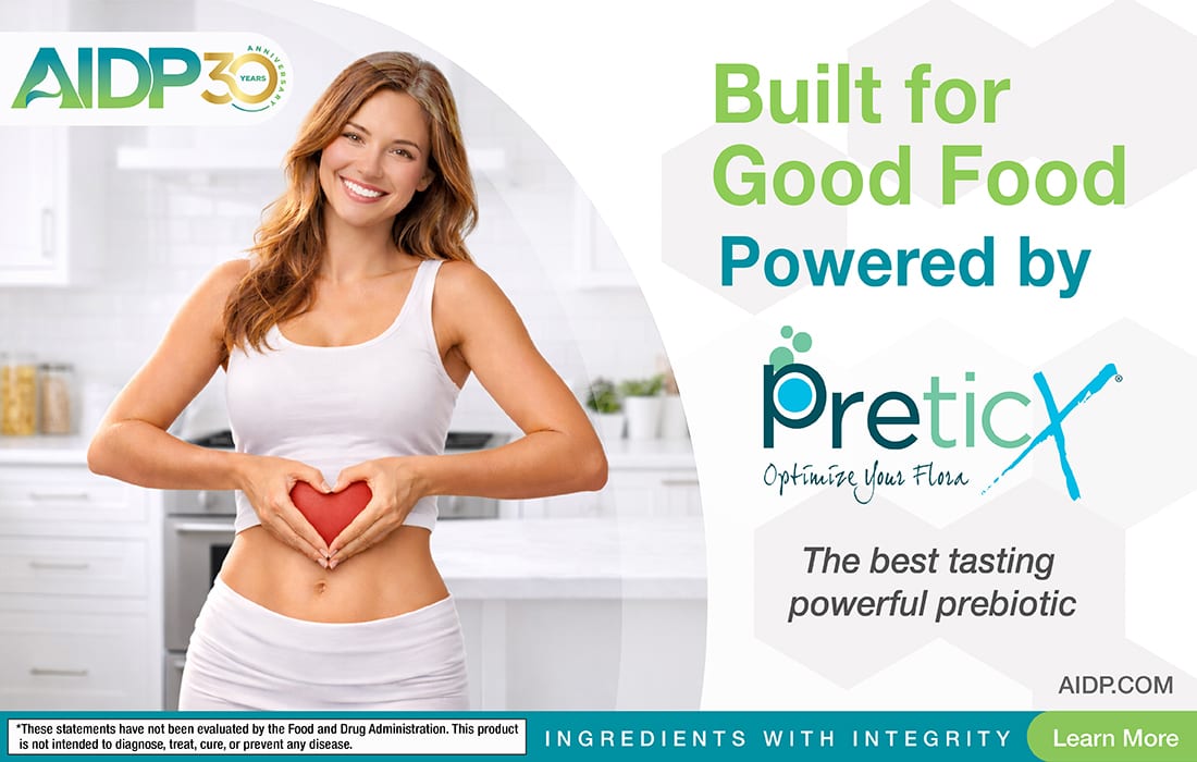 Woman holding a heart over her stomach, promoting PreticX, a powerful prebiotic for good food.
