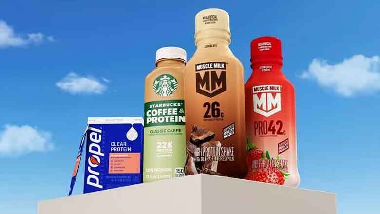 Assortment of protein drinks: Propel, Starbucks Coffee, and two Muscle Milk shakes, against a blue sky.