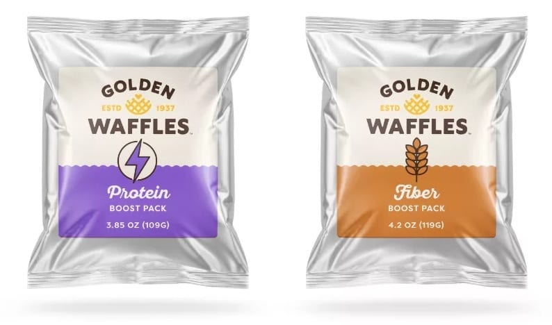 Two Golden Waffles boost packs: Protein (purple label) and Fiber (orange label) in silver foil packaging.