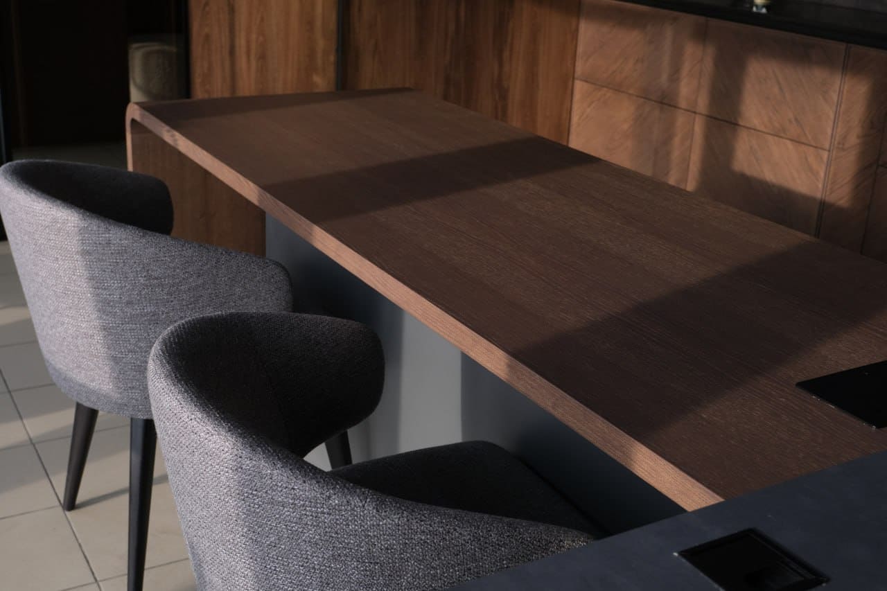 Interior design, Wood stain, Furniture, Flooring, Table, Floor, Lighting, Desk, Chair
