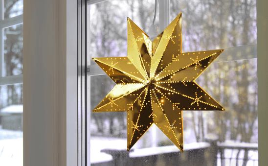 Creative arts, Christmas decoration, Woody plant, Gold, Window, Leaf, Wood, Fixture, Ornament, Tree