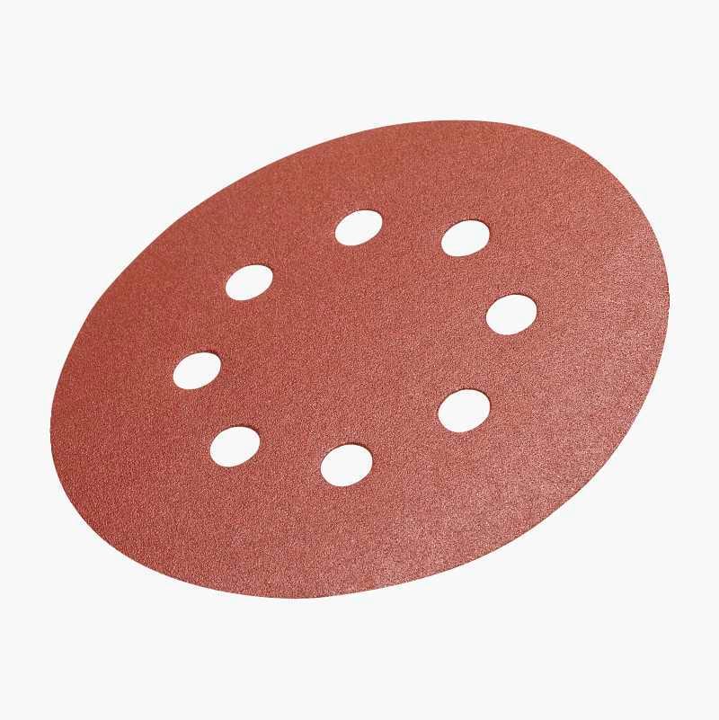 An oval, reddish-brown sanding disc with eight circular dust collection holes, presented on a white background.