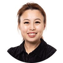 Smiling Asian woman with light brown hair and a dark shirt, headshot.