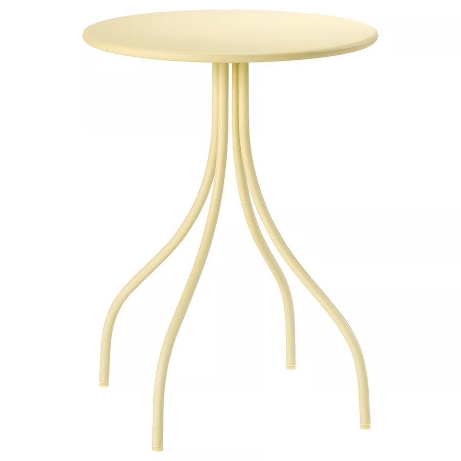 Pale yellow round table with a sculptural base of multiple thin, curved legs.