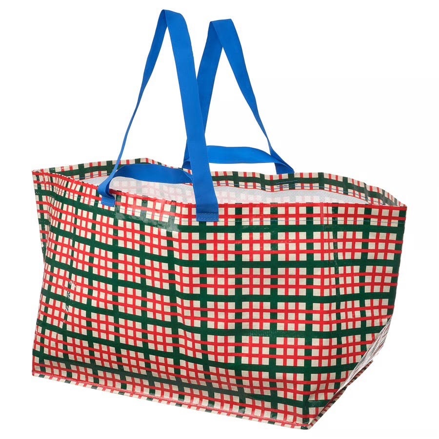 Large red, green, and white plaid reusable shopping bag with blue handles.