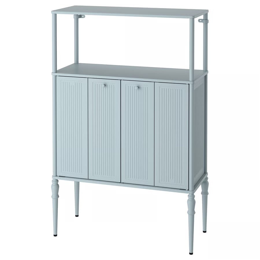 Light blue cabinet with an open shelf on top, four doors, and slender legs.