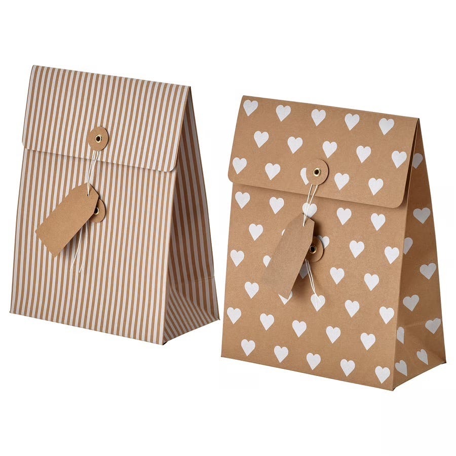 Striped and heart-patterned gift bags with tags on a white background.