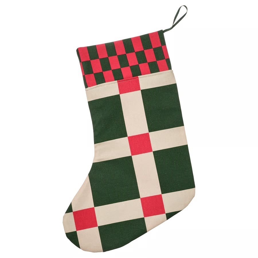 Christmas stocking in red, green, and cream plaid and checkerboard pattern.
