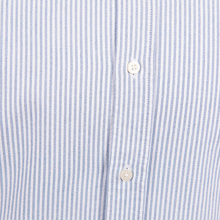 Close-up of a blue and white striped fabric, likely a shirt, with two white buttons.