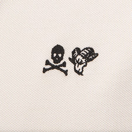 Black embroidered skull & crossbones and ram's head on light fabric.