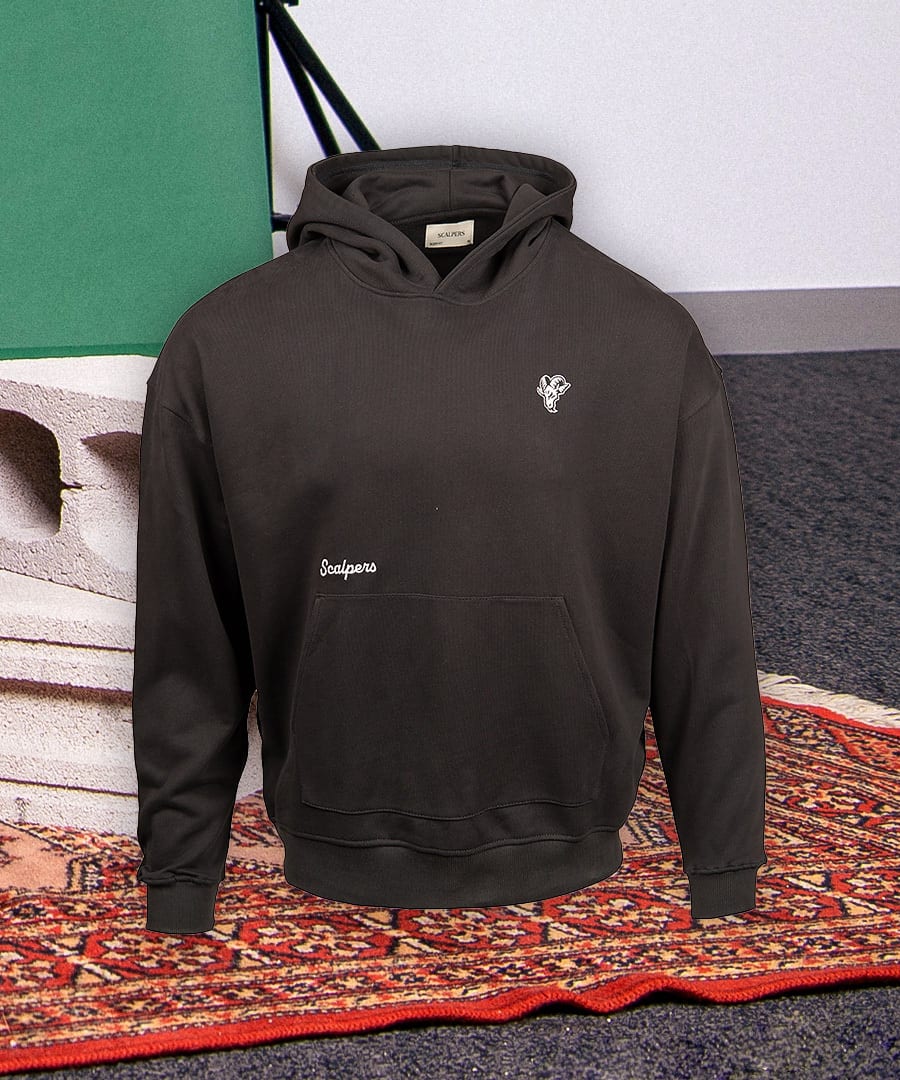 Oversized dark grey Scalpers hoodie featuring a white embroidered ram logo and script text on the chest.