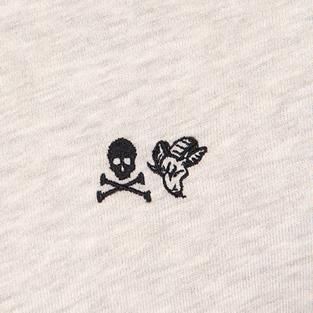 Black embroidered skull and crossbones with a peeled banana on light grey fabric.