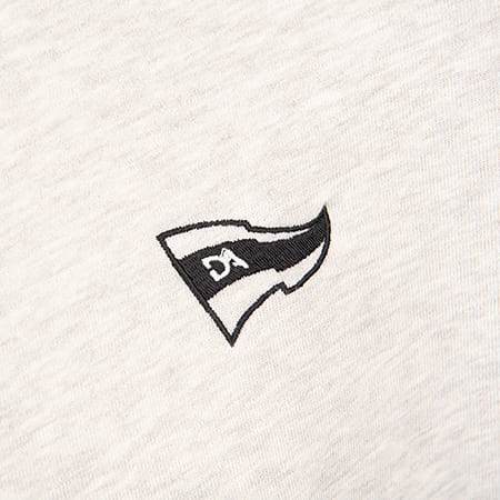 Embroidered black and white flag logo with 'DA' letters on a light grey marled fabric.