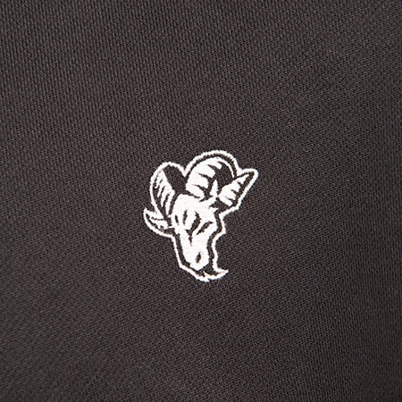 White embroidered ram's head logo on a black fabric.