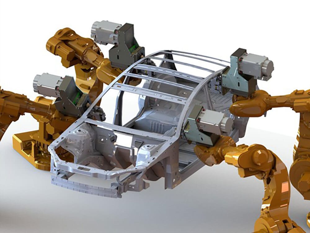 Robotic arms assembling a car chassis.