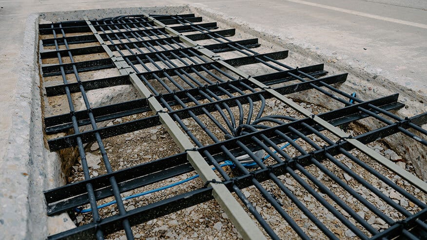 Grid of tubes and bars in a trench for an underground system.