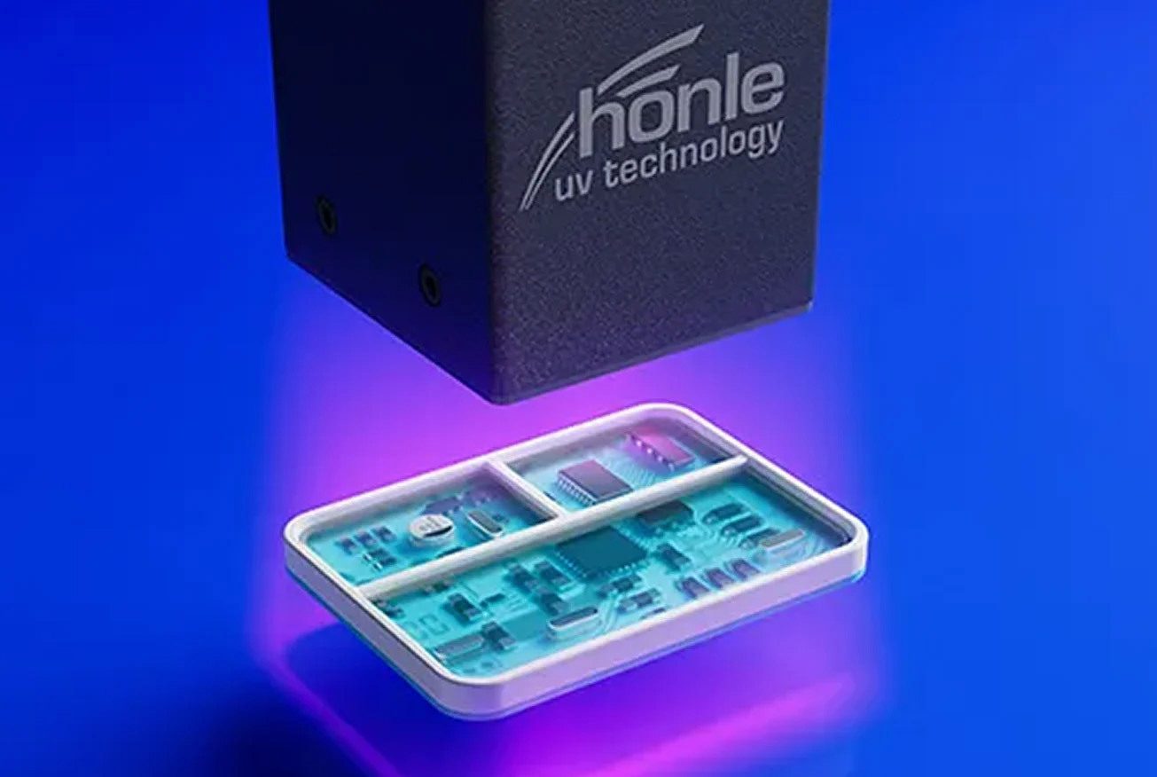 Honle UV technology unit curing electronic components with purple light.